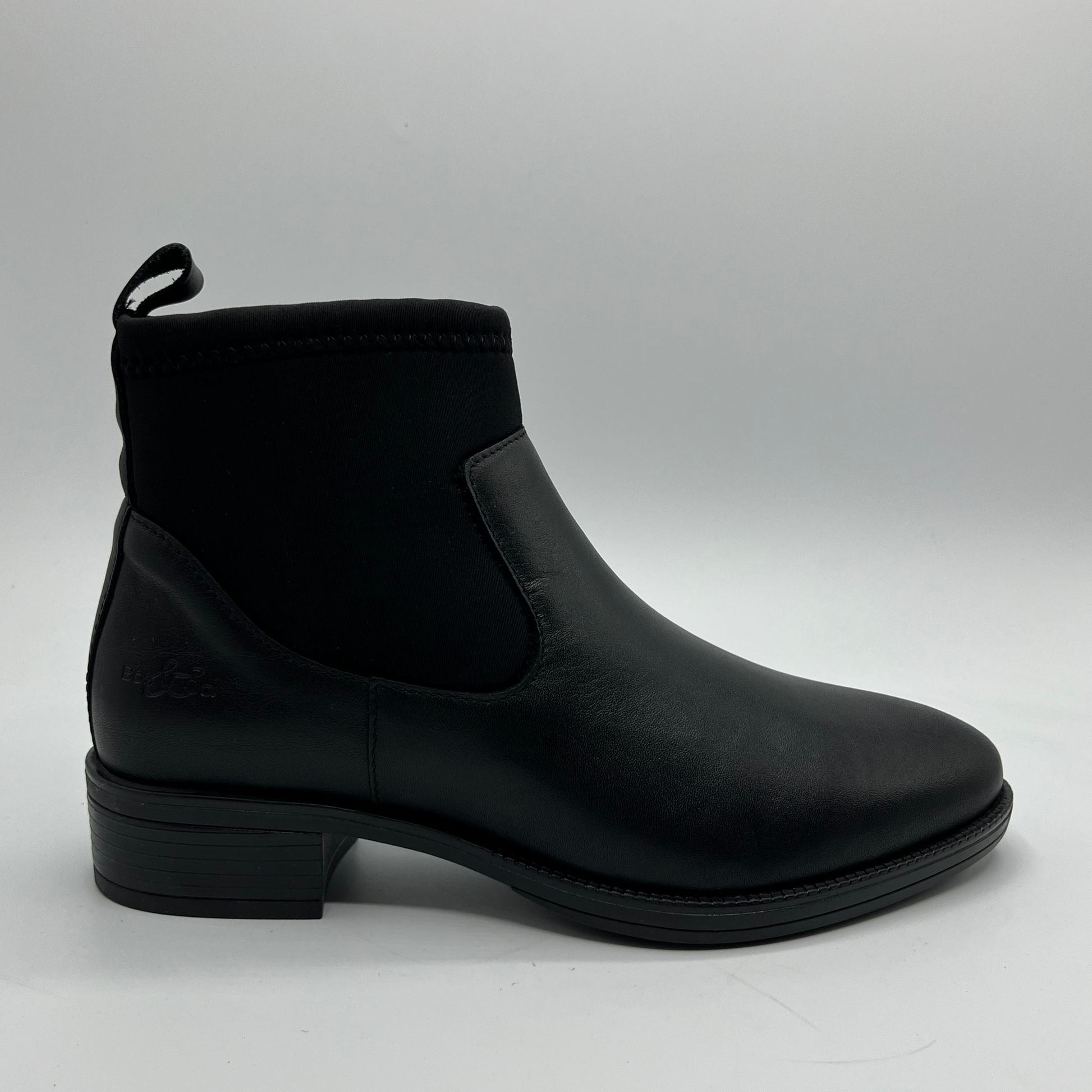 Black ankle boot on a gray background