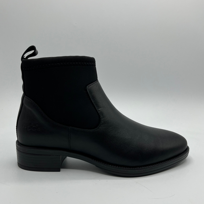 Black ankle boot on a gray background