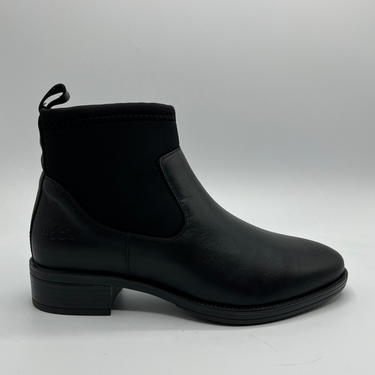 Black ankle boot on a gray background