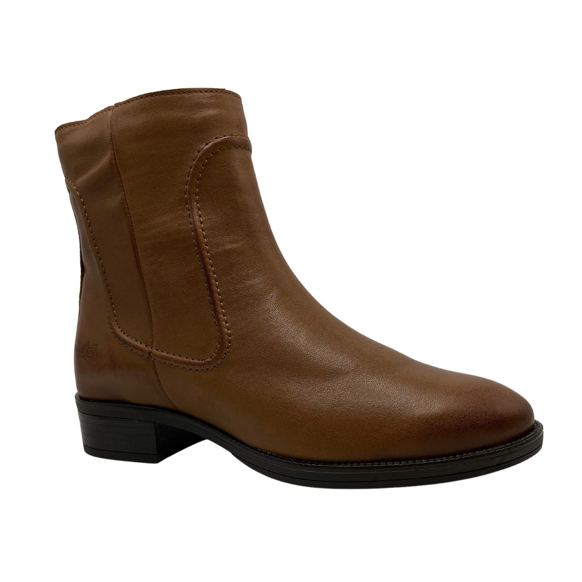 Angled view of rich tan leather short boot with a low block heel and side zipper closure