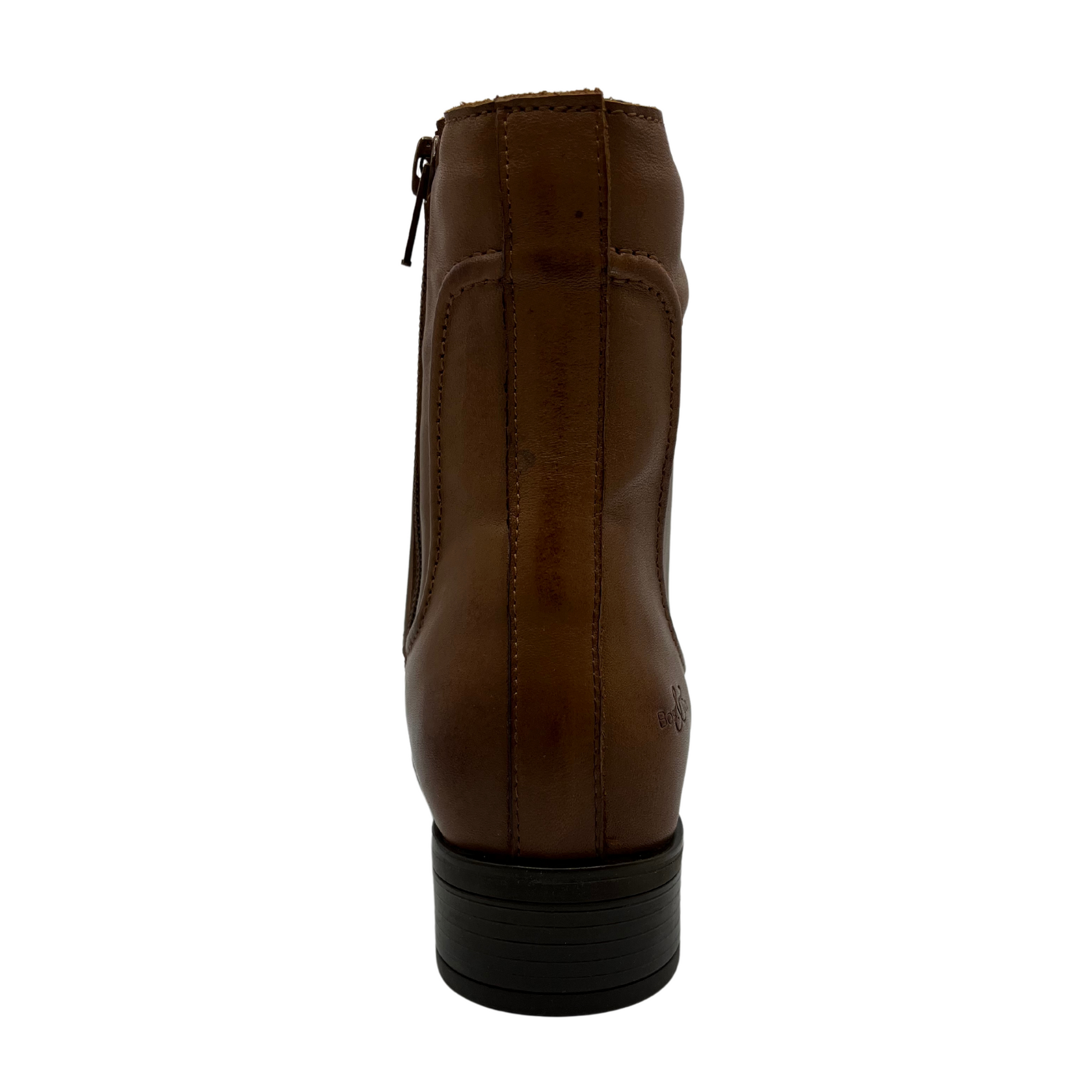 Back view of rich tan leather short boot with a low block heel and side zipper closure