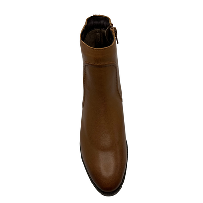 Top view of rich tan leather short boot with a low block heel and side zipper closure