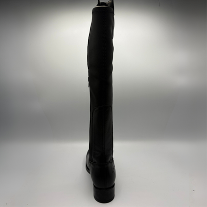 Back view of a black leather boot with an elasticated back panel on a white background