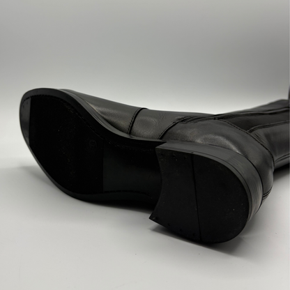 Bottom view of a black leather boot with an elasticated back panel on a white background