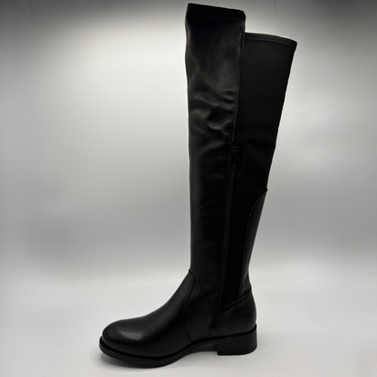 Left facing view of a black leather boot with an elasticated back panel on a white background