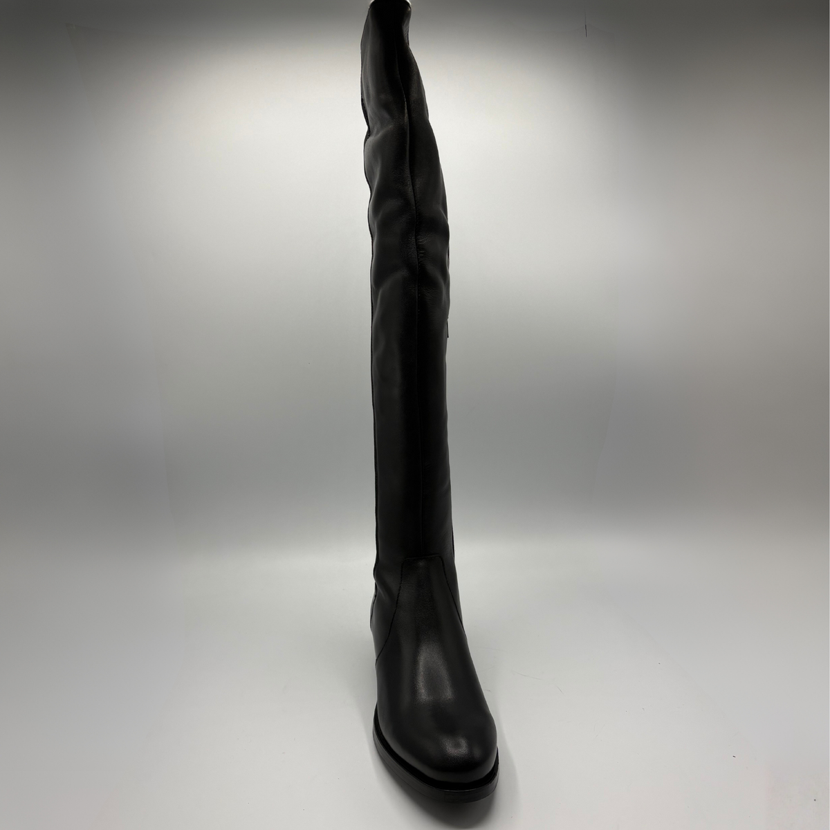Front view of a black leather boot with an elasticated back panel on a white background