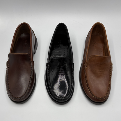 Three pairs of leather loafers on a white background