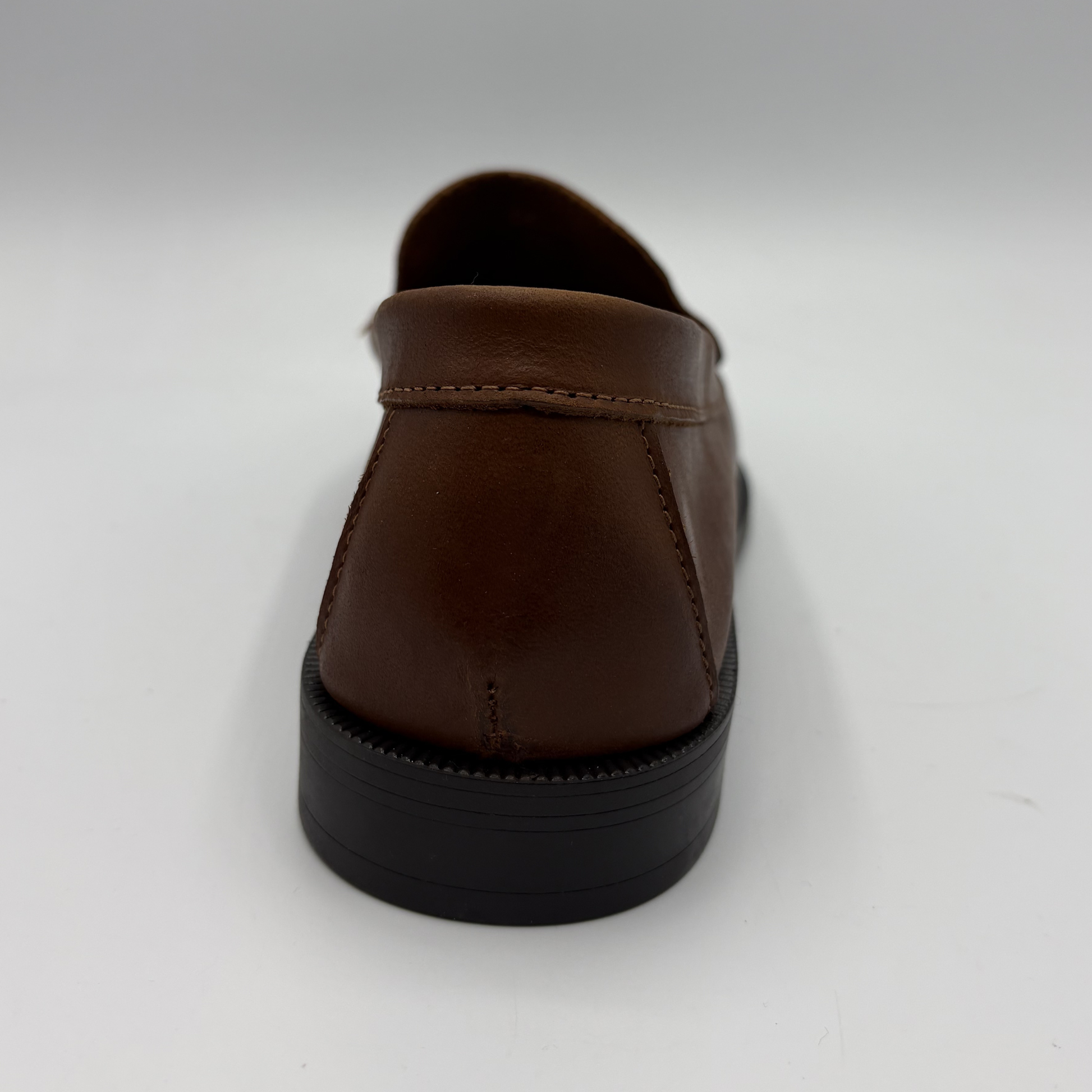 Brown leather shoe on a white background
