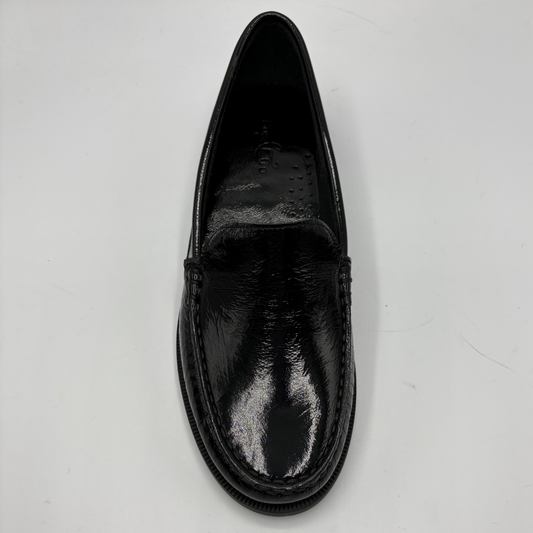 Black leather loafer shoe on a light gray background