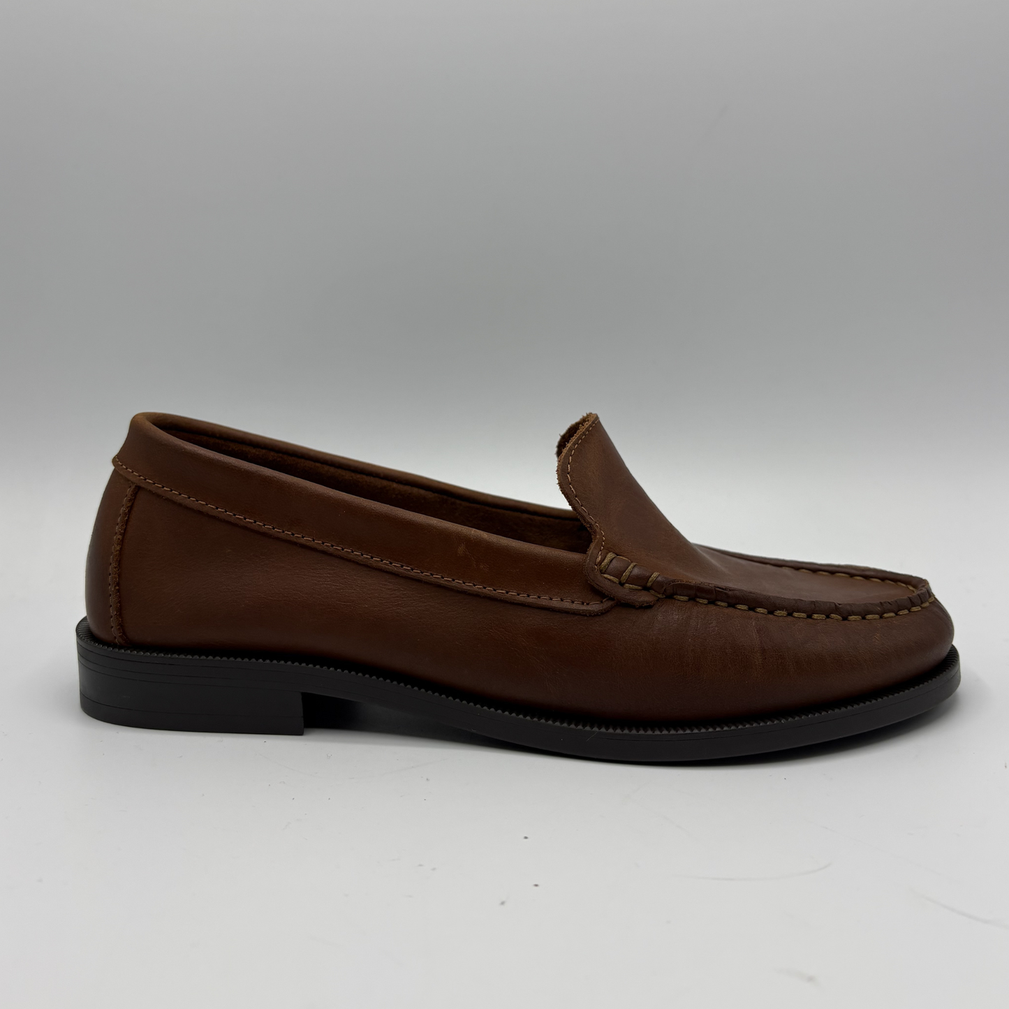 Brown loafer shoe on a white background