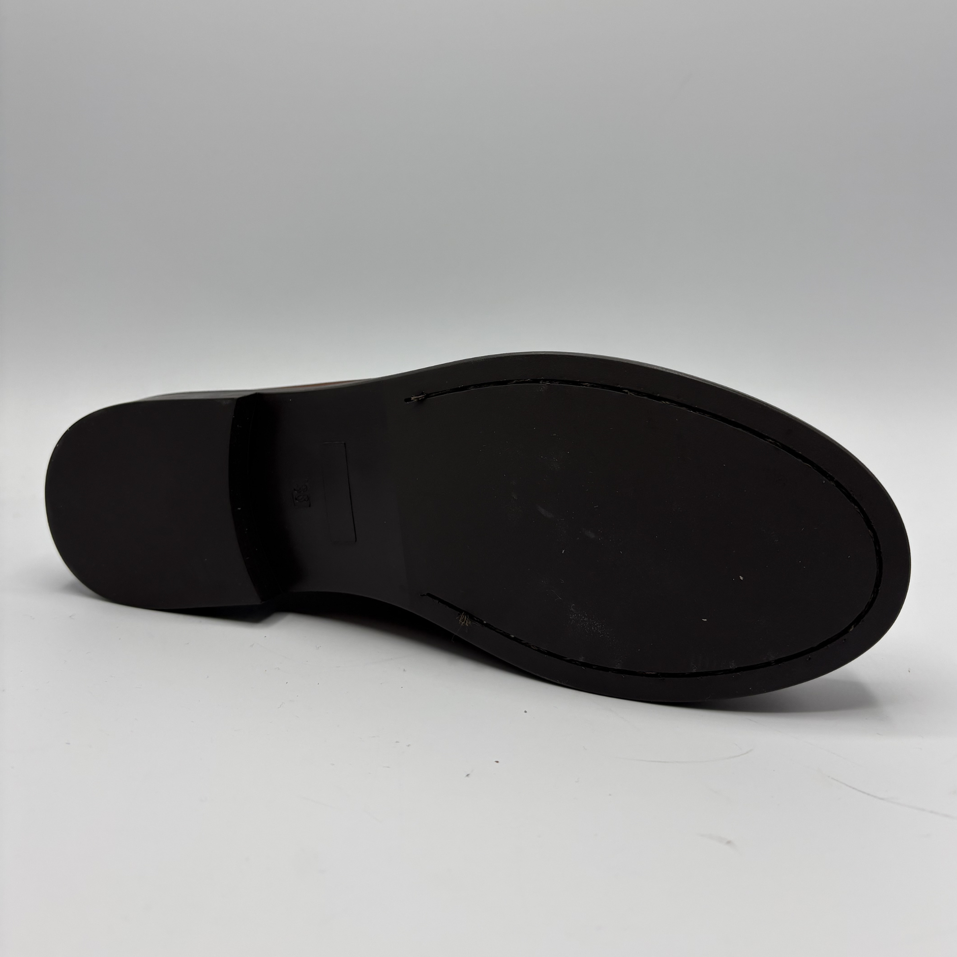 Black shoe sole on a gray background
