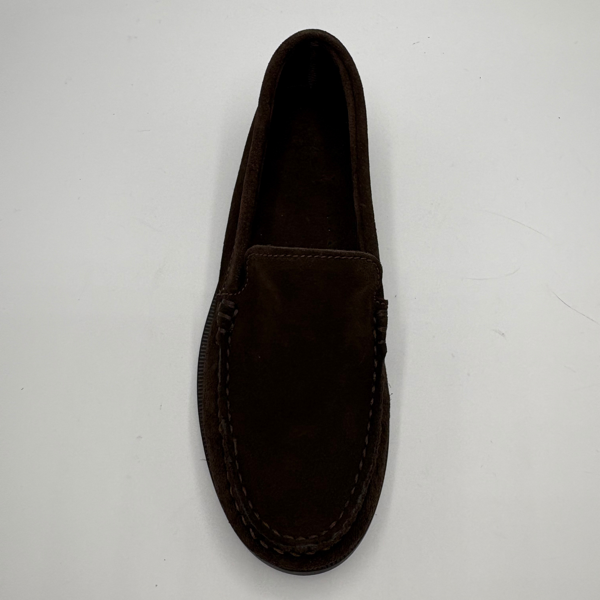 A single dark brown suede loafer shown from a top-down view on a plain white background.