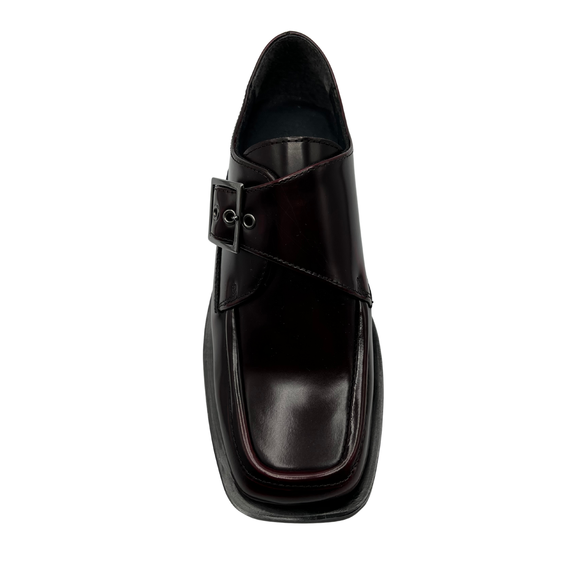 Top view of bordo leather loafer with silver buckle on upper, low heel and leather lining.