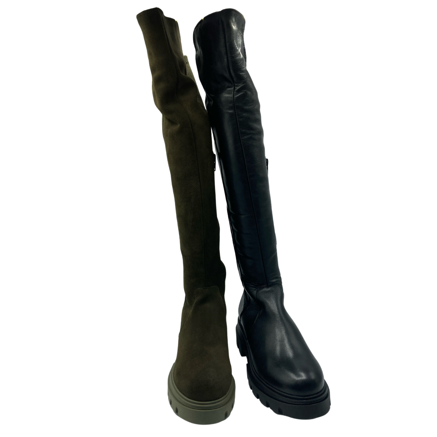 View of two thigh high boots side by side. The one on the left is khaki suede and the one on the right is black leather. Both are thigh high and both have platform soles