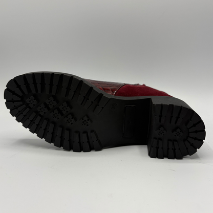 Bottom view of a short boot with a red croc front panel and a sturdy block heel