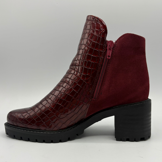 Left facing view of a short boot with a red croc front panel and a sturdy block heel
