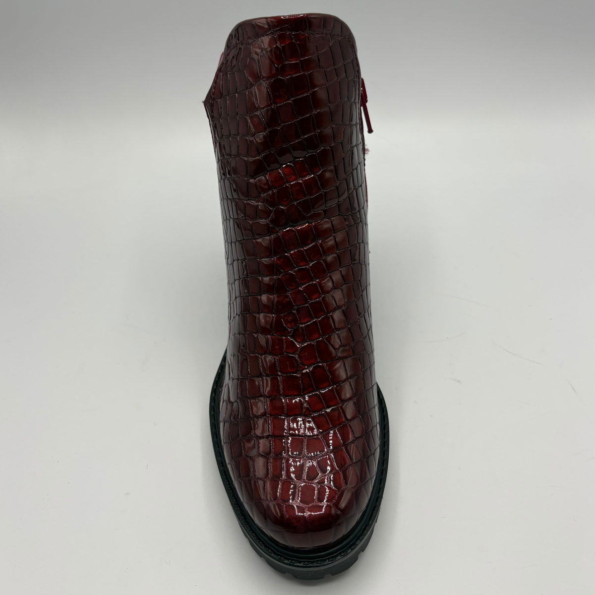 Top view of a short boot with a red croc front panel and a sturdy block heel