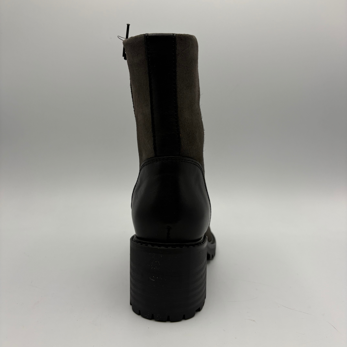 Back view of a two toned black short boot with a stacked heel and rounded toe