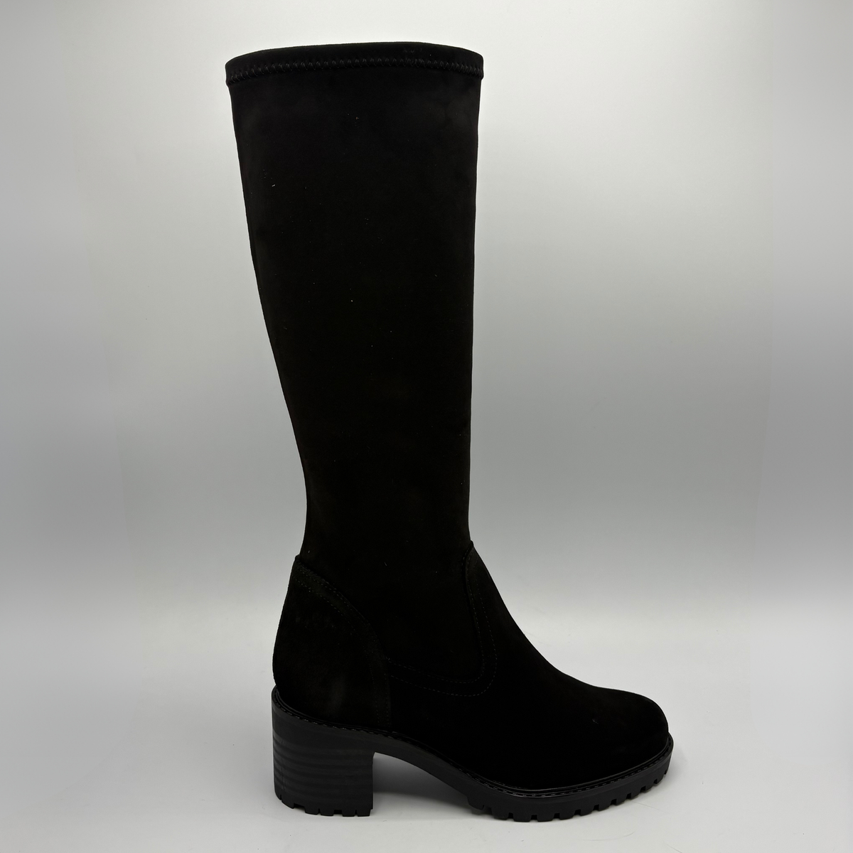 Right facing view of a black tall boot with a chunky heel