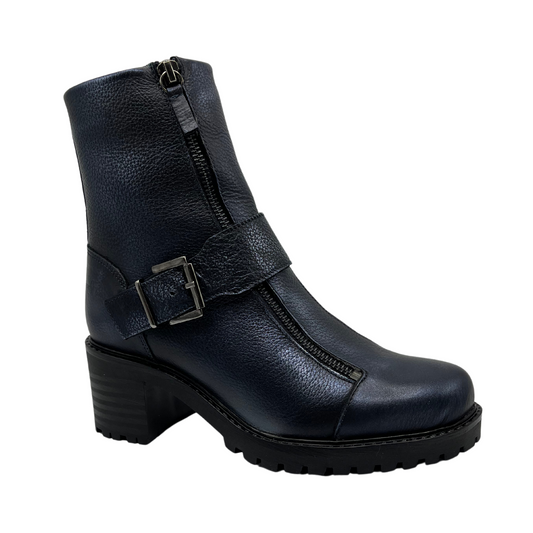 Angled view of dark blue leather boot with chunky heel, mid height strap and off center zipper closure and side zipper closure