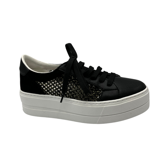 Angled view of black leather sneaker with platform white rubber outsole. Mesh side with gold details and black laces.