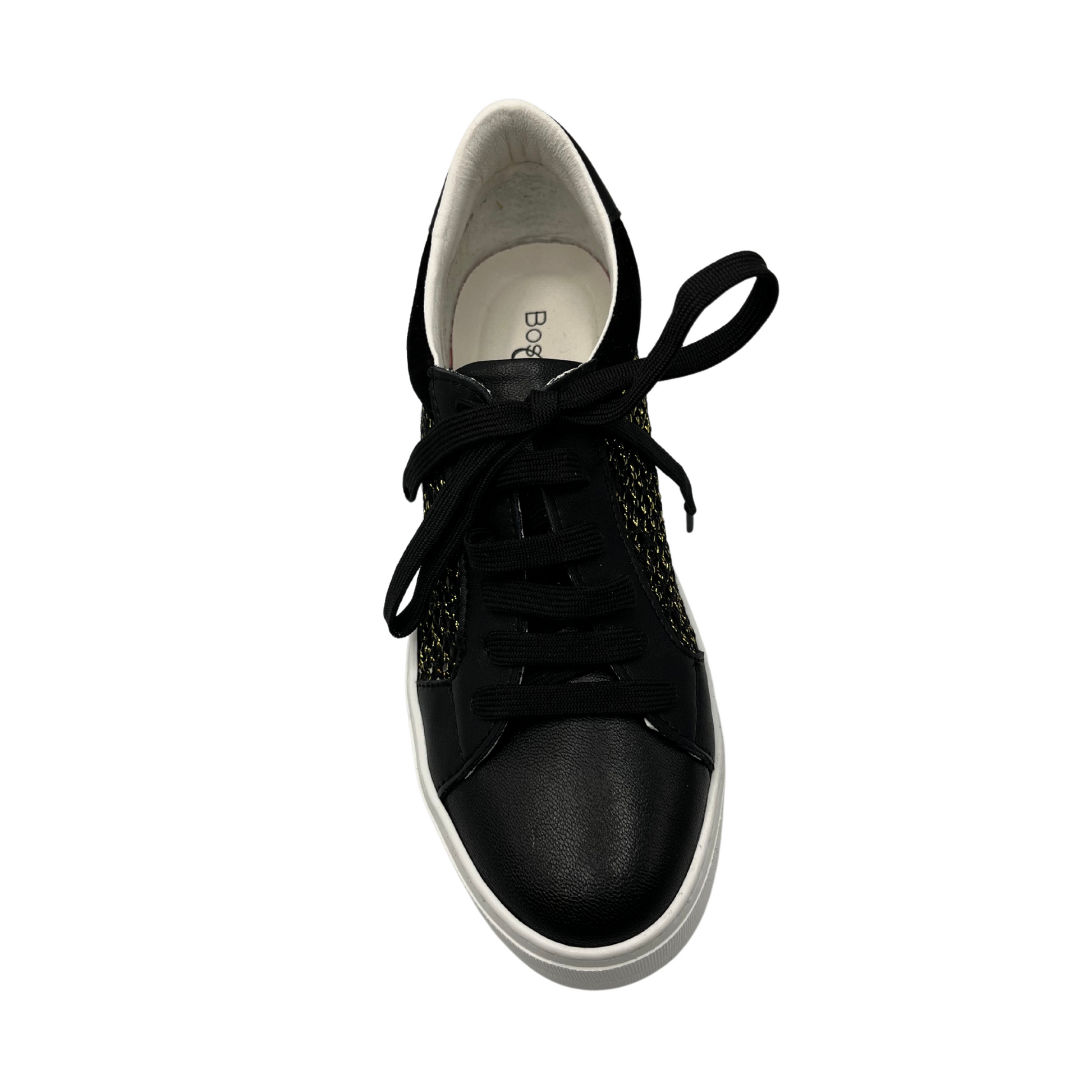 Top view of black leather sneaker with platform white rubber outsole. Mesh side with gold details and black laces.