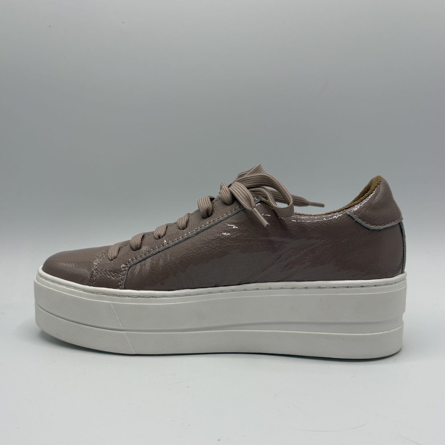 Brown platform sneaker on a gray background