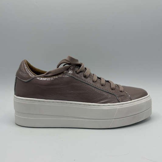 Brown leather sneaker with white sole on a gray background
