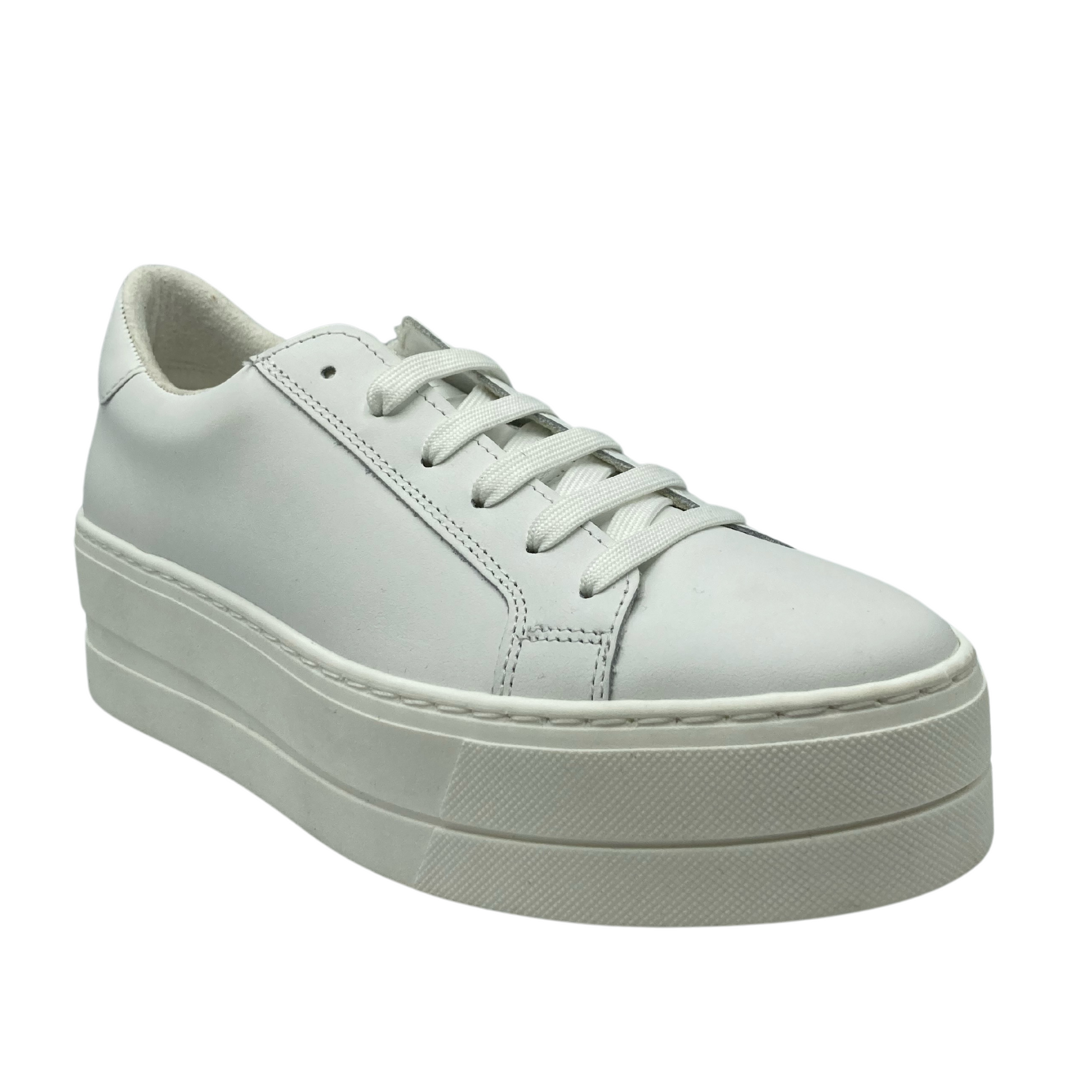 45 degree angled view of white leather sneaker with white rubber platform sole