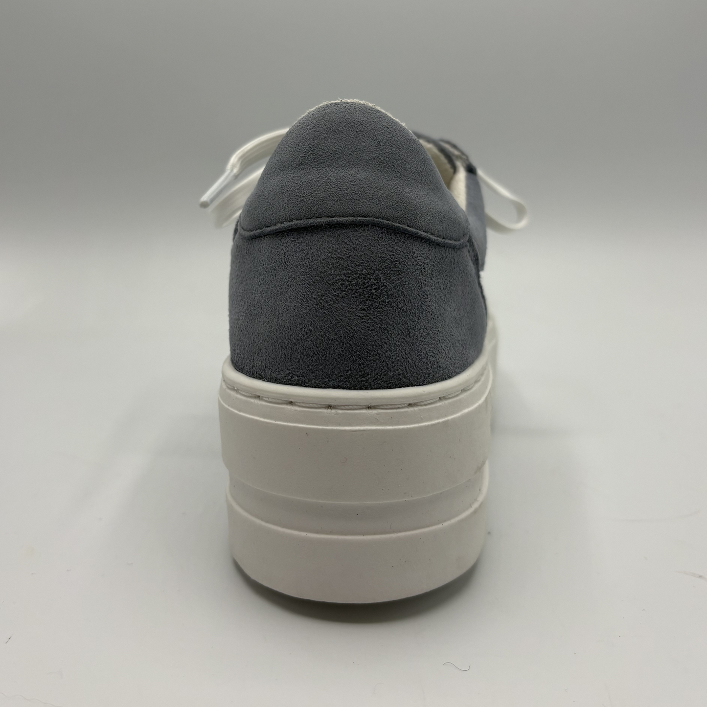 Dark gray sneaker with white sole on a light gray background