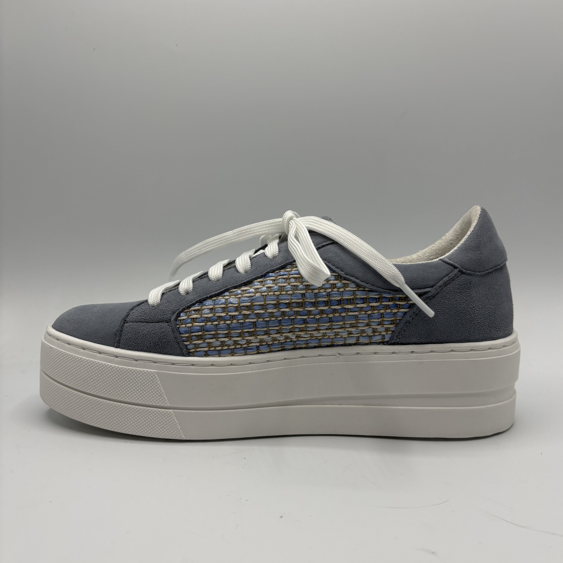 Gray sneaker with white sole on a gray background