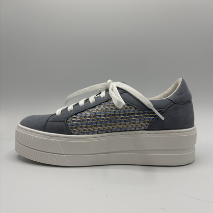 Gray sneaker with white sole on a gray background