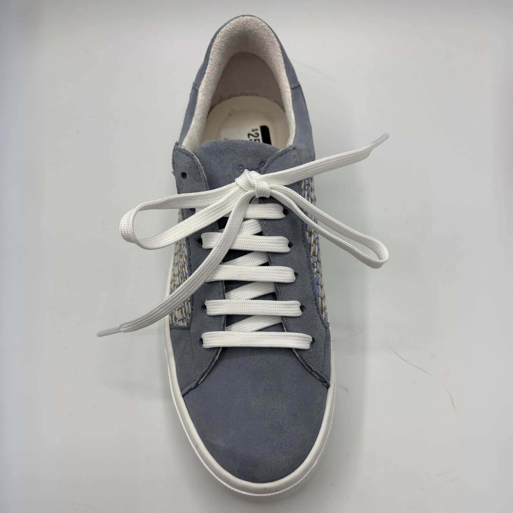 Gray sneaker with white laces on a light gray background