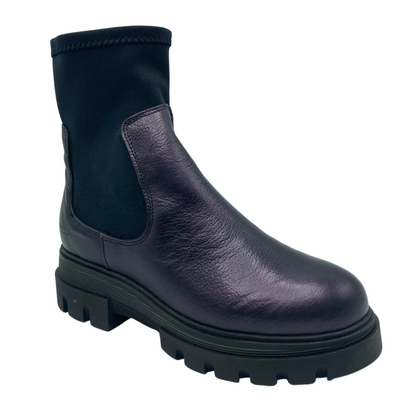 45 degree angled view of dark purple and black leather boot with stretchy shaft and rubber sole