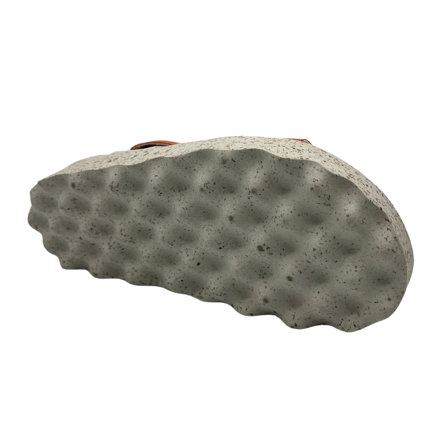 Bottom view of orange strapped sandal with contoured footbed and speckled white and brown outsole