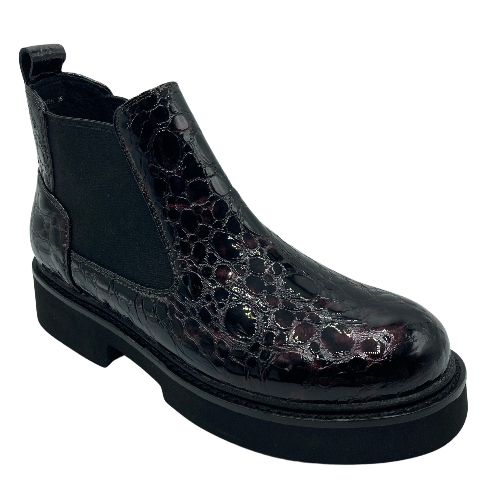 45 degree angled view of textured leather ankle boot with elastic gore and black rubber outsole