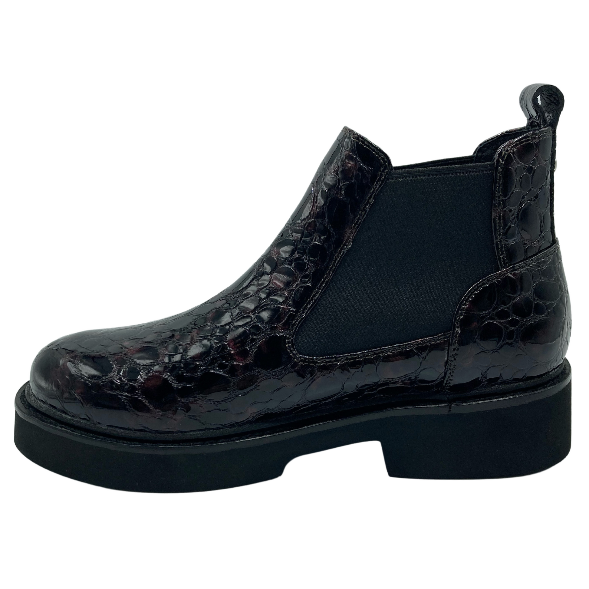 Left facing view of textured leather ankle boot with black rubber outsole and elastic double gore