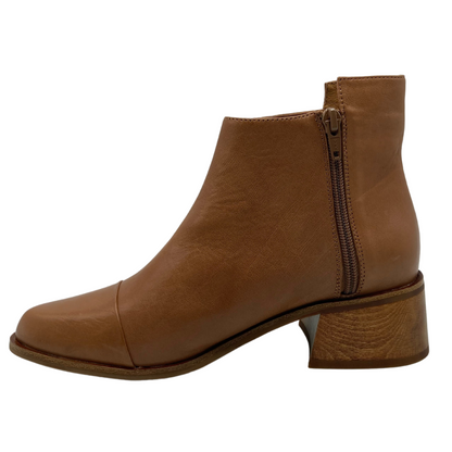 Left facing view of pointed toe, leather ankle boot with block heel and zipper closure