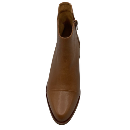 Top view of brown, leather boot with pointed toe and zipper closure