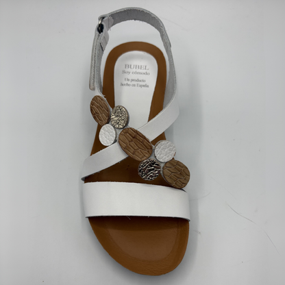 White sandal with decorative elements on a white background