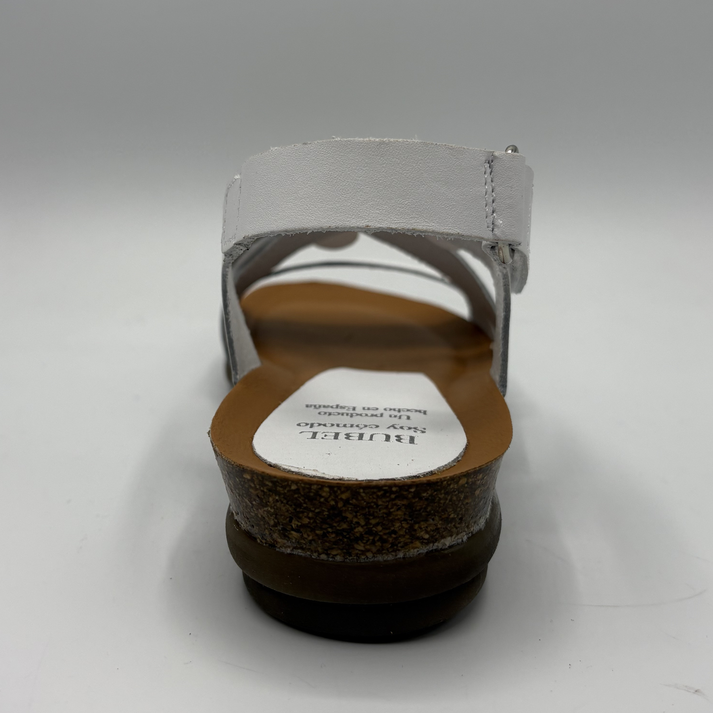 Back view of a sandal with a visible brand label on a white background