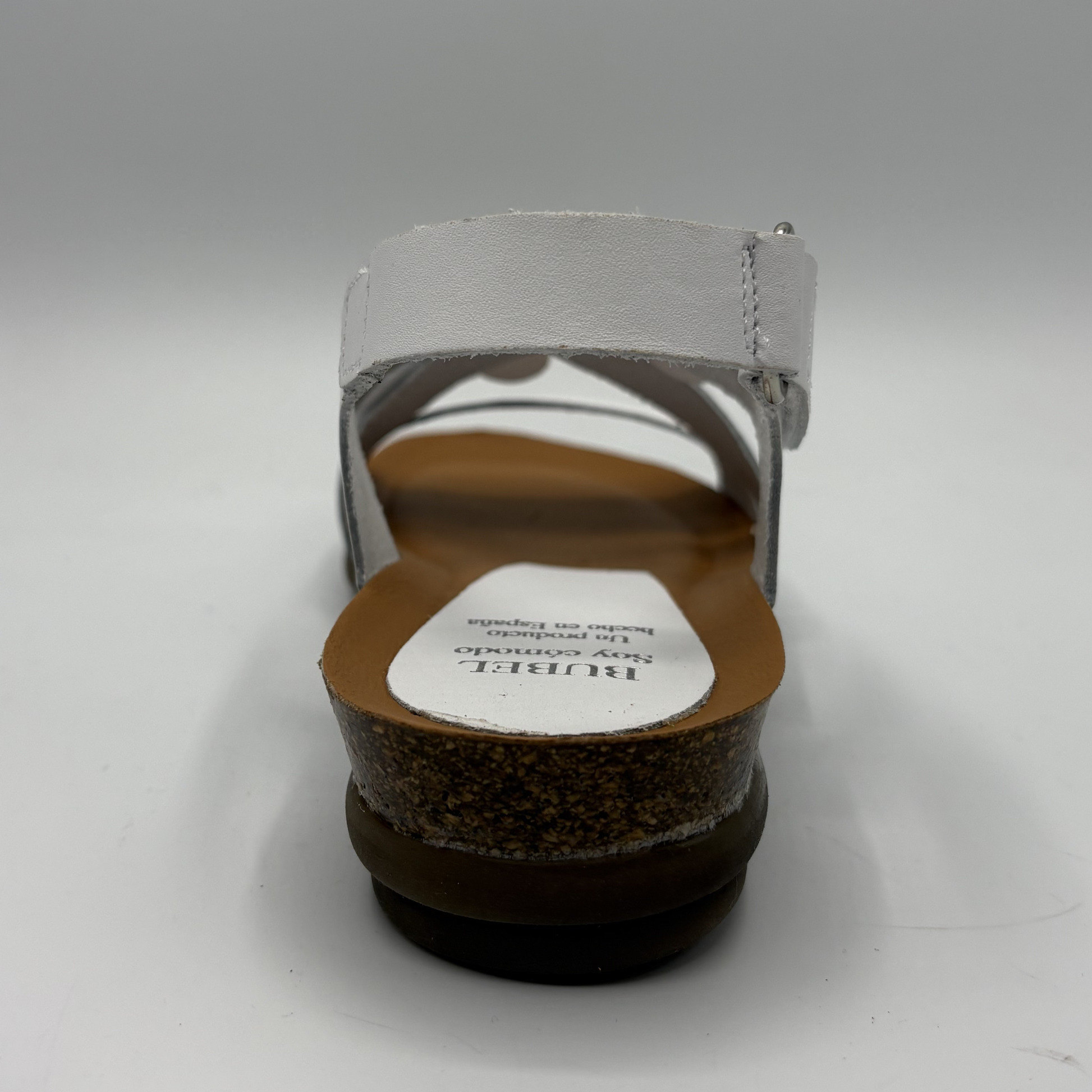 Back view of a sandal with a visible brand label on a white background