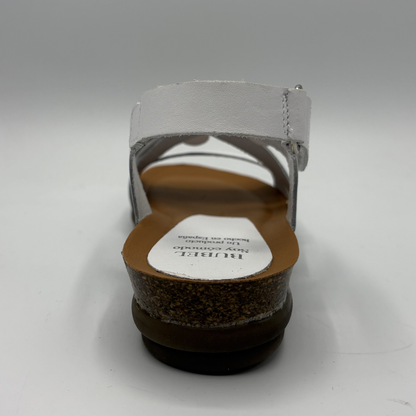 Back view of a sandal with a visible brand label on a white background