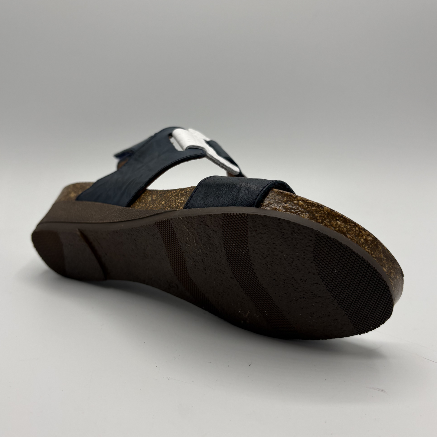 Black sandal with cork sole on a gray background
