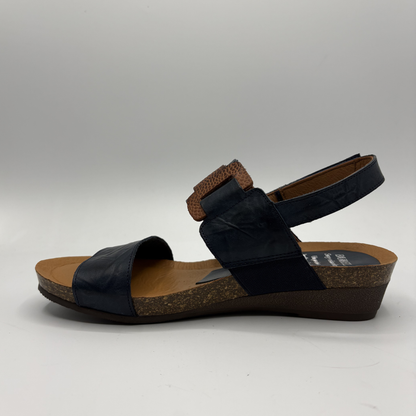 Black sandal with cork sole on a gray background