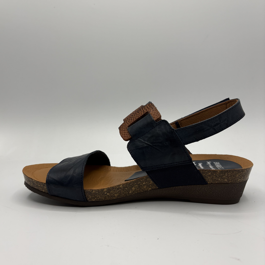 Black sandal with cork sole on a gray background