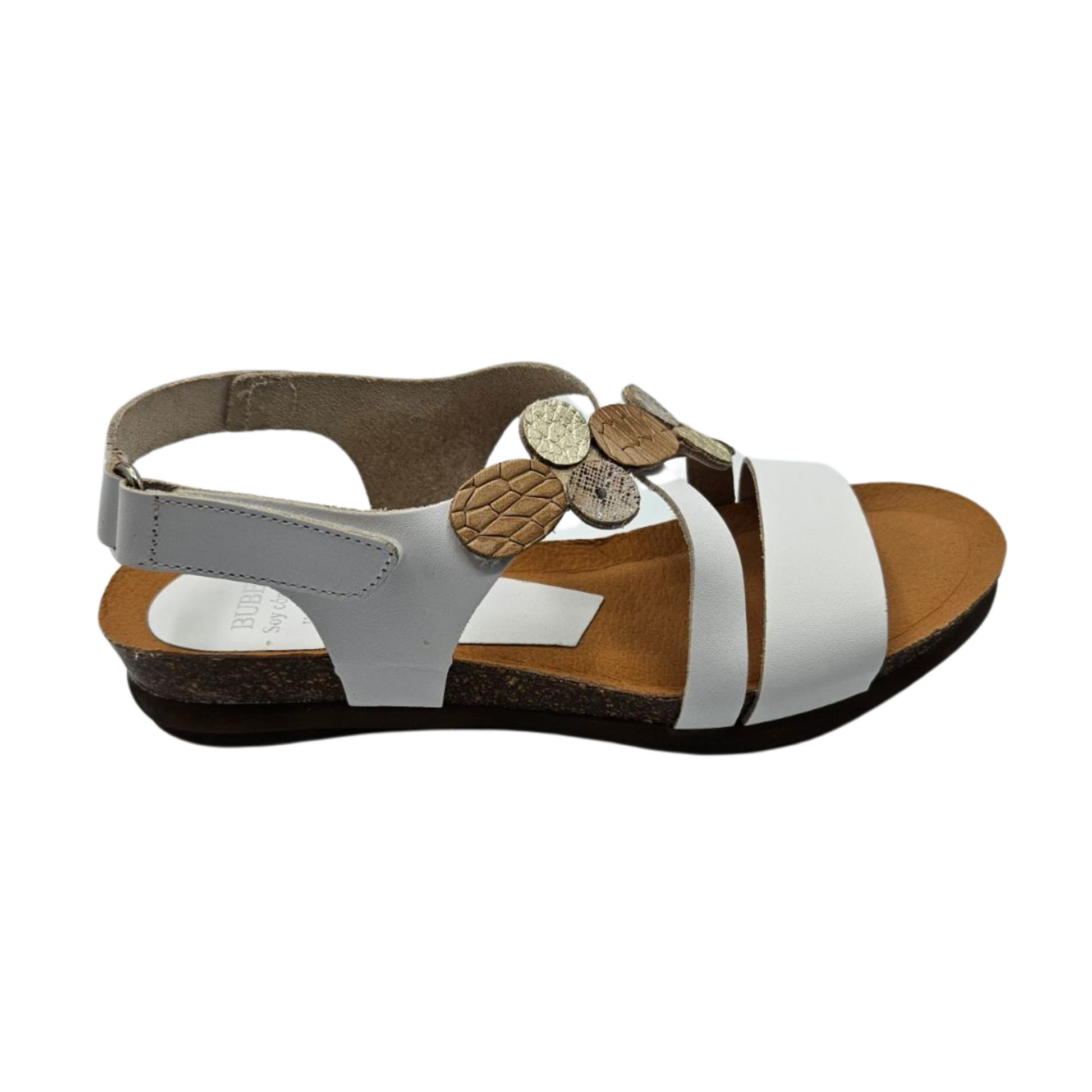 Right facing view white leather sandal with mixed metallic accents on upper strap. It has a velcro ankle strap and rounded toe.