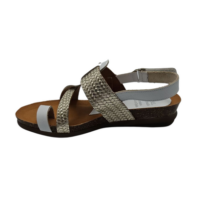 Left facing view of white and gold leather sandal with a toe strap and velcro ankle strap. Braided detail on the gold strap and cushioned footbed