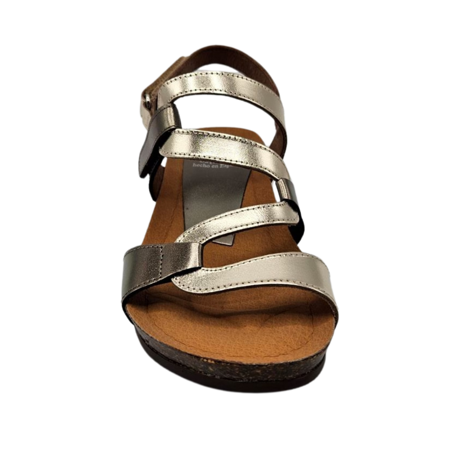 Front facing  view of metallic leather sandal with wavy strap design, rounded toe and slight wedge heel.