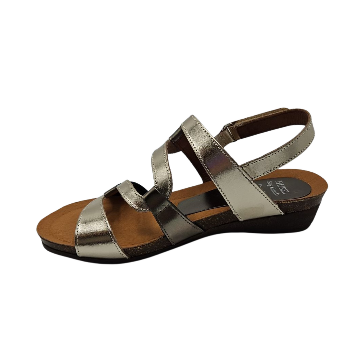Left facing  view of metallic leather sandal with wavy strap design, rounded toe and slight wedge heel.